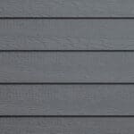 Gray wooden siding panels arranged horizontally with a textured, woodgrain pattern visible on each board. The surface appears even and well-maintained.