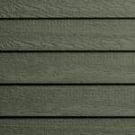 Close-up of green wooden siding panels with a horizontal orientation, showing a wood grain texture and slight gaps between each plank.