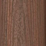 Close-up of a brown wood surface with vertical grain patterns and natural textures, showing a mix of darker and lighter streaks and scattered knot-like markings.