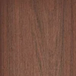 Close-up of a wooden surface with a smooth texture, featuring a natural brown color and subtle wood grain patterns running vertically.