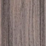 Close-up of a wooden surface with a textured grain pattern. The wood is light brown with darker and lighter streaks running vertically, showing natural lines and knots.
