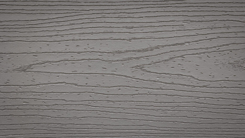 Close-up of a textured gray surface resembling wood grain patterns, with horizontal lines and subtle variations creating a realistic wood-like appearance.