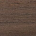 Close-up of a wooden surface with a smooth texture, featuring dark brown and light brown grain patterns running horizontally across the image.