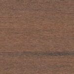Close-up of a brown wooden surface with visible horizontal grain lines and textured natural patterns, giving a rustic appearance.