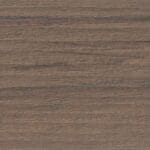 Close-up of a textured wood surface with a brown finish, showing natural grain patterns and subtle variations in color and lines running horizontally.