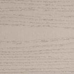 A close-up view of a beige surface with a wood grain texture, featuring horizontal grooves and lines that mimic the appearance of natural wood.