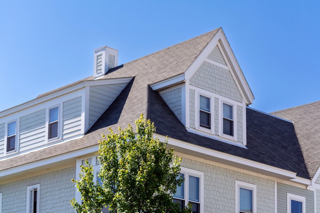 Two-story house with light gray shingle siding