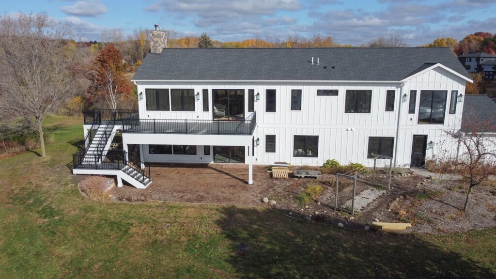 A modern white two-story house with fiber cement siding