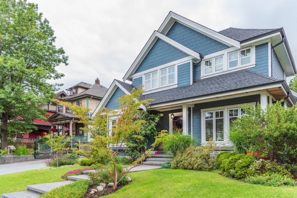 A modern two-story blue house with quality siding and white trim
