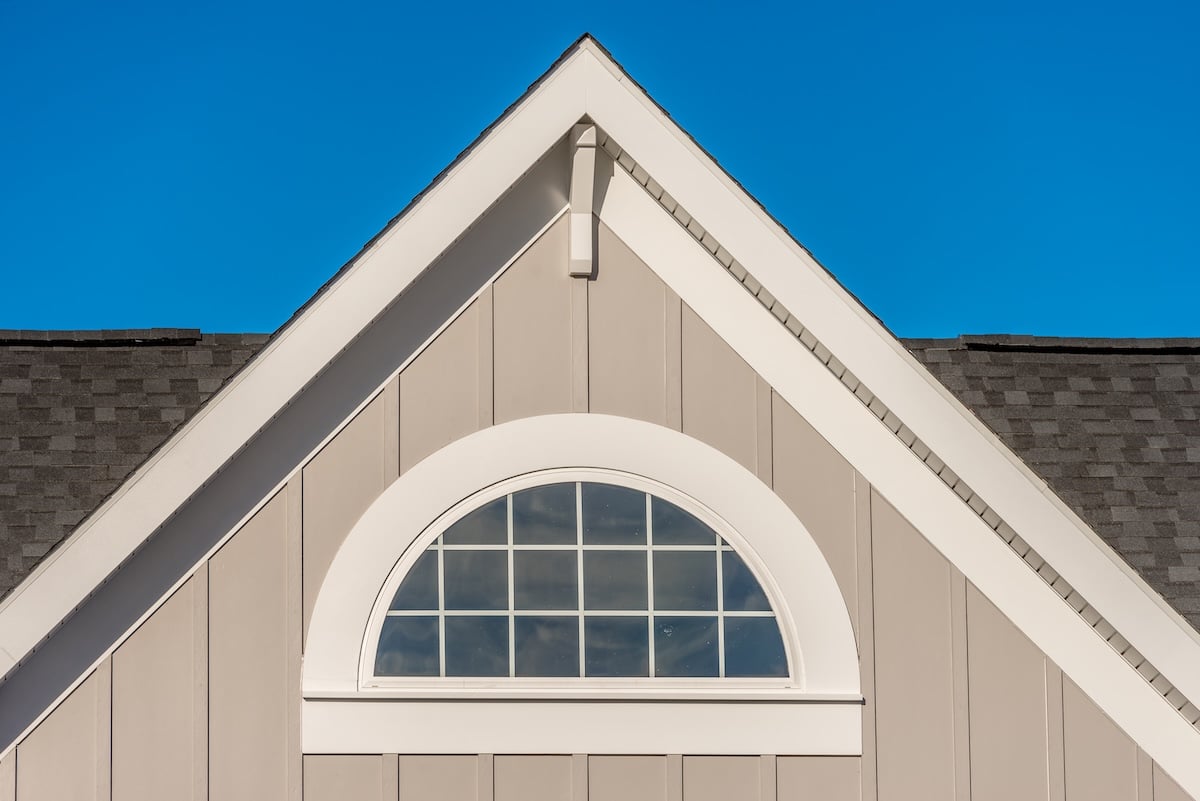 Close-up of a house’s gable roof with vinyl siding panels