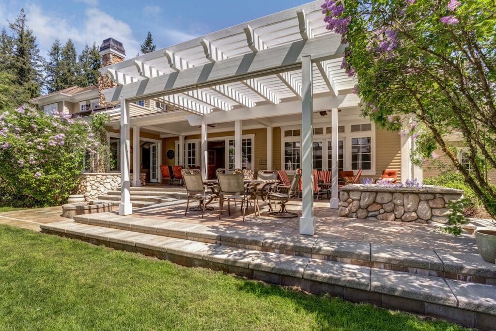A spacious deck with pergola featuring an outdoor dining set