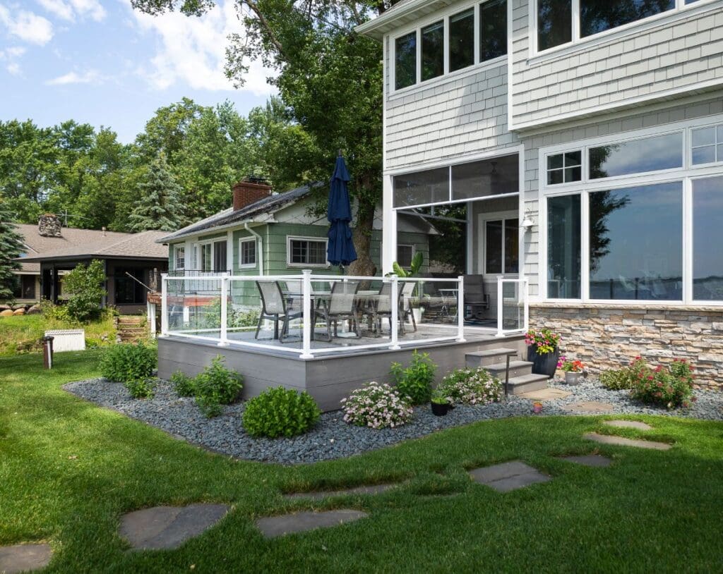 A modern house with a glass-railed deck