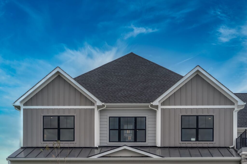 A modern house with gray board and batten siding