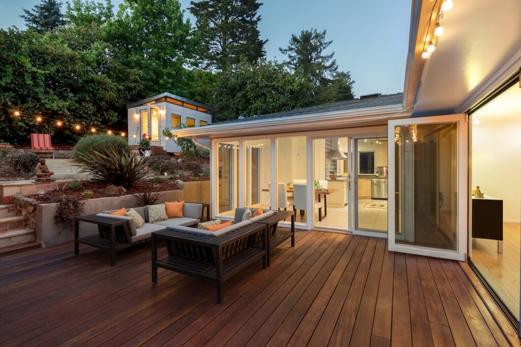 Modern patio with varied deck sizes, outdoor seating area, and string lights.
