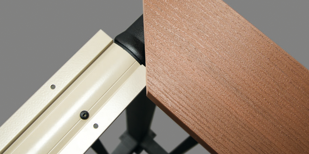 Close-up of a beige metal rail and a brown wood-textured board meeting at an angle, offering inspiration for composite railing ideas or stylish drink rails against a gray background.